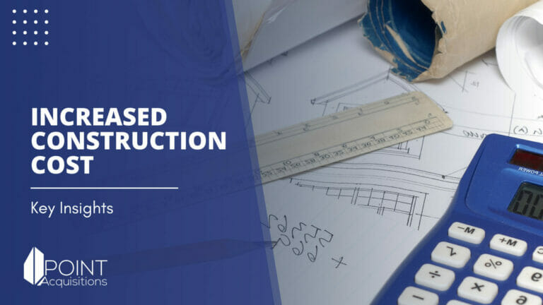 a calculator and a ruler with a background of construction plan